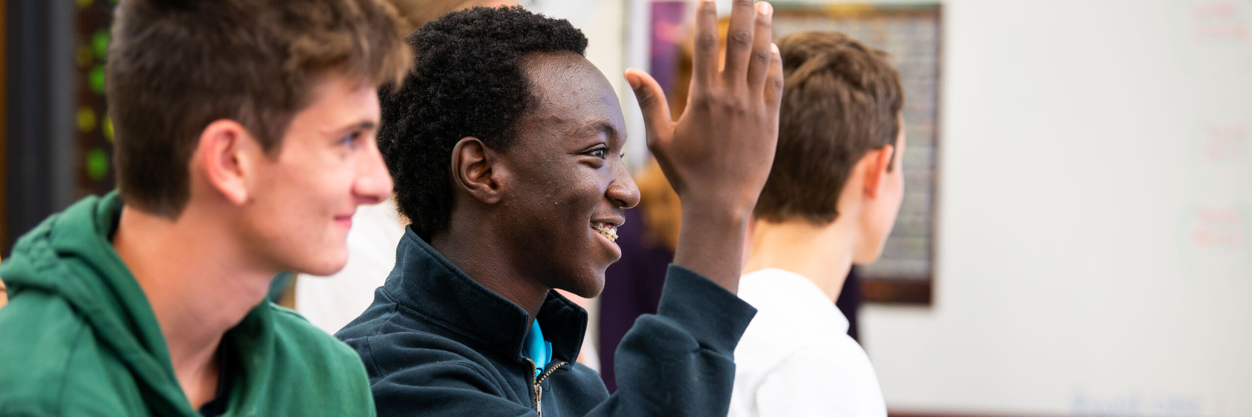 A student raises his hand.